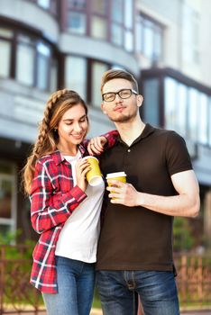 Portrait of happy couple walk on the street with coffee