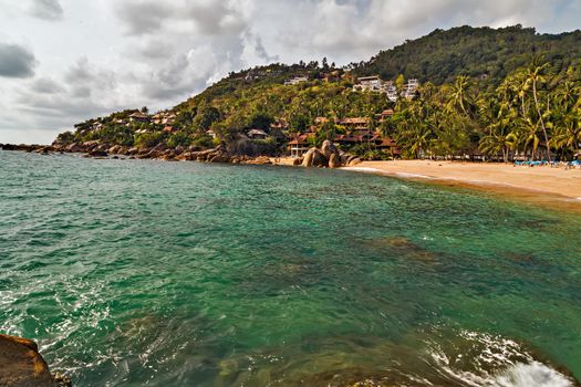 Sea summer landscape, Tropical rock Coral Cove beach with coconut palm trees. Koh Samui, Thailand.