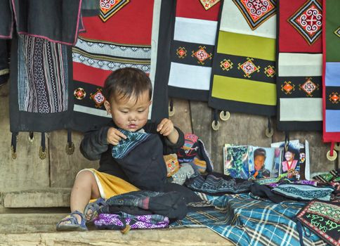 LAO CAI, VIETNAM - NOV 21, 2014: the little girl Hmong Ethnic Minority People near Sapa, Lao Cai, Vietnam.