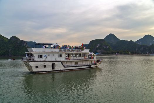 Ha Long bay islands Tourist Junks in Halong Bay South China Sea, Vietnam. UNESCO World Heritage Site Asia. Indochina Discovery.