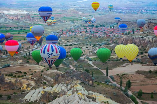 GOREME,TURKEY - OCTOBER 19, 2015: Colorful hot air balloons flying over the valley at Cappadocia, Anatolia, Turkey.UNESCO world heritage Volcanic mountains in Goreme national park.