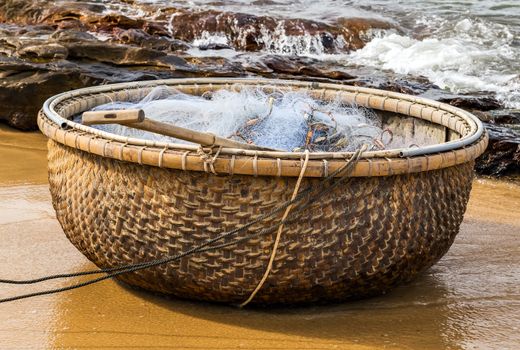 Vietnamese old boat and equipment trap, fishing net in beach
