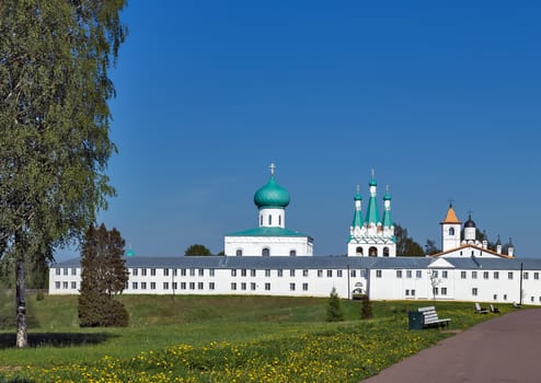 the Holy Trinity Cathedral with old well preserved frescoes, the triple bell tower and the church of the Protection of the Mother of God. Alexander of Svir Monastery. Leningrad Oblast. Russia