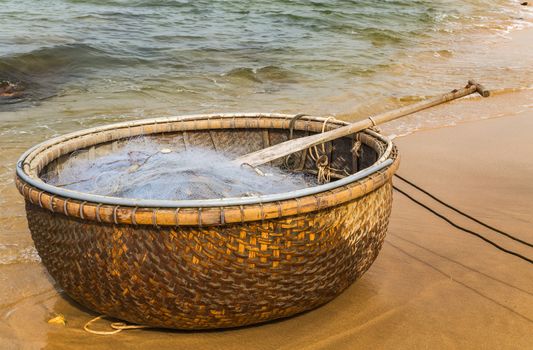 Traditional old Vietnamese fishing boat in the basket fishing net.
