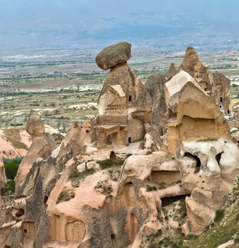 fairy chimneys sandstone in the canyon near Cavusin village, in Cappadocia, Turkey Travel background