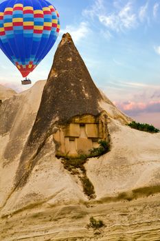 Hot air balloons flying in sunset Volcanic rock formations in Cappadocia, Anatolia, Turkey. Travel background