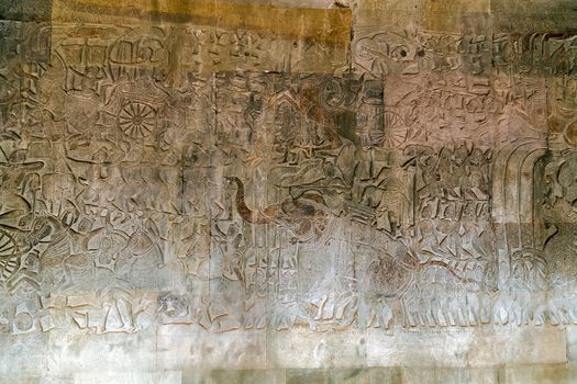 Khmer relief carving of gods fighting demons. Inner wall of the temple of Angkor Wat, Siem Reap, Cambodia.
