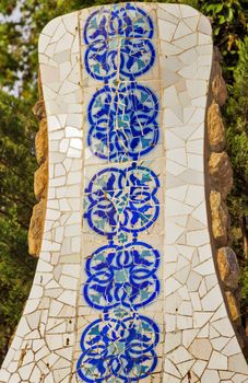 Frame ceramic tile grunge background covered with tile-shard mosaic, Parc Guell designed by Antoni Gaudi located on Carmel Hill, Barcelona, Spain.