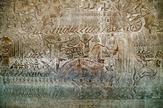 Khmer relief carving of gods fighting demons. Inner wall of the temple of Angkor Wat, Siem Reap, Cambodia.