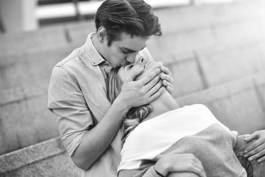 Happy to spending time together. Young beautiful couple outdoor fashion portrait. Attractive couple hugging and boy kissing a girl.