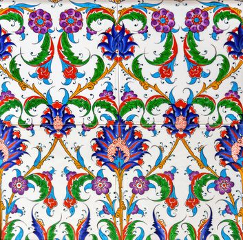 painting a ceramic tile with floral, tile mosaic background, surface textures.