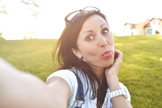 Fun Emotion, Adult woman having fun in nature, taking selfie. fun