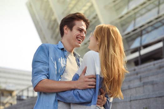 Beautiful couple in love dating outdoors and smiling.