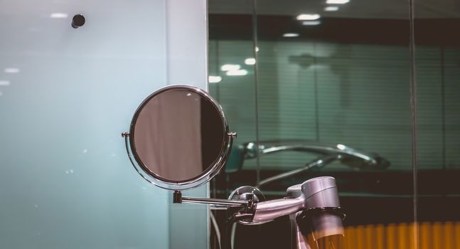 magnifying mirror on the sink in the bathroom of a luxury hotel