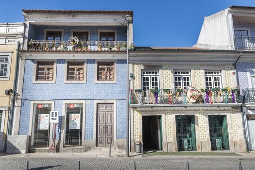 Ovar, Portugal - February 18, 2020: architectural detail of the typical houses of the city decorated for the carnival where people are walking on a winter day