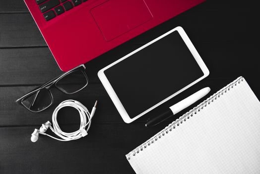 Home work concept, Tablet Pc, notepad and Laptop on wooden background, planning personal income. preparation to work. free copyspace