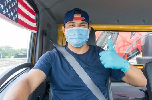 Close-up photos of Asian truck drivers wearing masks to protect against dust and the spread of the flu. Covid 19. Inside the car front