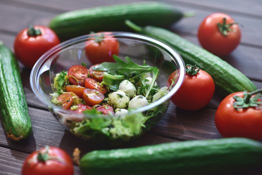 Tasty and useful. Vegetable mix salad with mozzarella cheese and pesto sauce. Healthy and dietary meals.