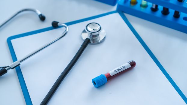 The Corona Virus Vaccine is placed on a scientist's desk in a medical laboratory. Scientists are working on a vaccine to treat patients with emerging infectious diseases.