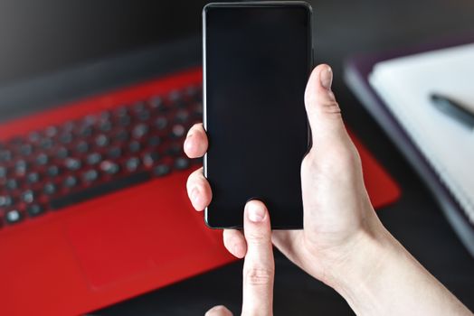 right hander man using his smartphone. concept. Working place of lefty. Work and study table concept. close-up view. free copy space