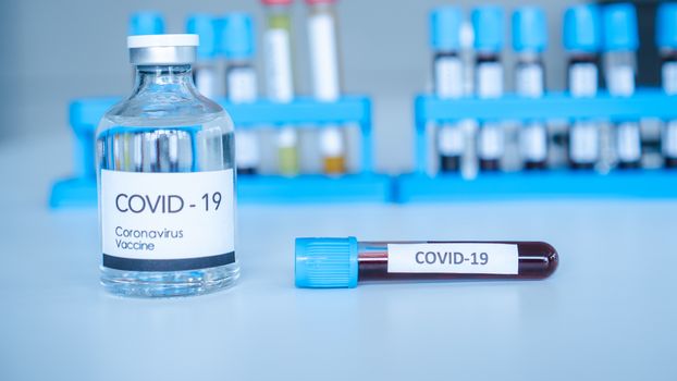 The Corona Virus Vaccine is placed on a scientist's desk in a medical laboratory. Scientists are working on a vaccine to treat patients with emerging infectious diseases.