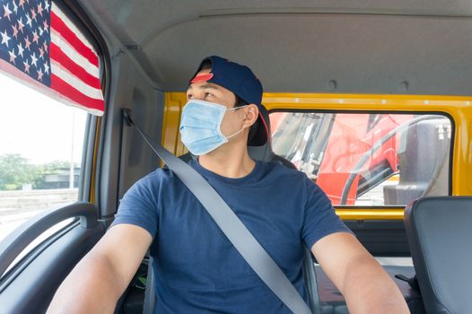 Close-up photos of Asian truck drivers wearing masks to protect against dust and the spread of the flu. Covid 19. Inside the car front