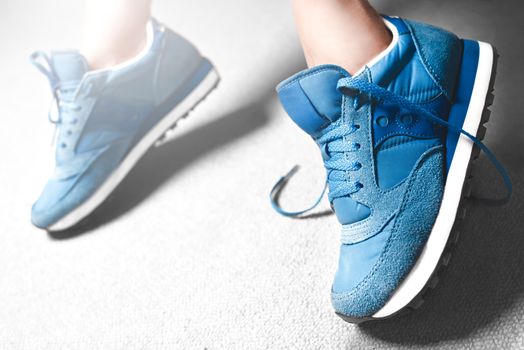 Close up women's legs on white background, blue Sneakers ,Women's shoes,spot focus. sport sneakers