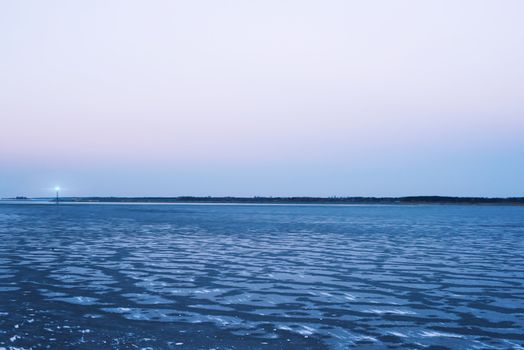 Frozen sea, the lighthouse, evening sky  romantic