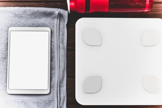 dieting and control calories for good health concept. smart weight scales tablet device and Drinking bottle on board. fitness concept