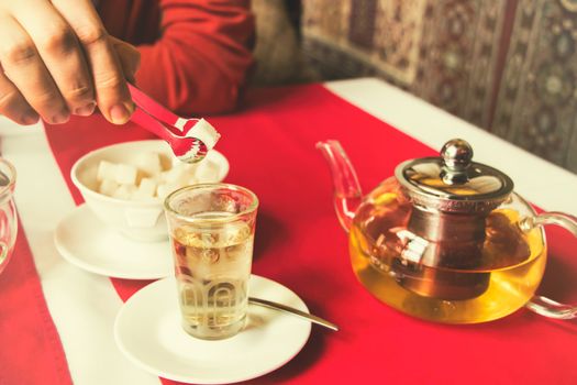 man puts sugar in tea, restaurant,East style