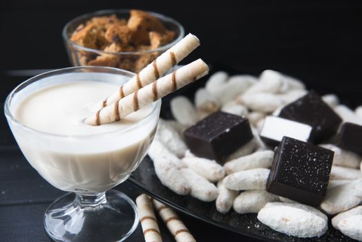 sweets, straws in the cream, cookies and candies on the table