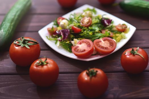 Healthy dietary meals. Mix salad of vegetables on a wooden background. Hello spring. Healthy body