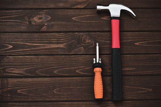 close-up tools as hammer and screwdriver on a wooden background. work concept.