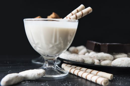 sweets, straws in the cream, cookies and candies on the table