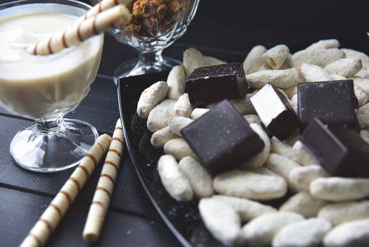 sweets, straws in the cream, cookies and candies on the table