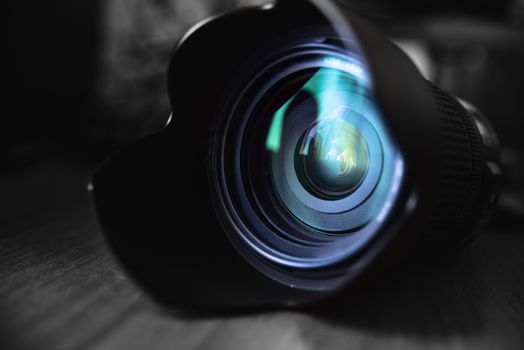 Optical Lens lies on the table, photo, reflections