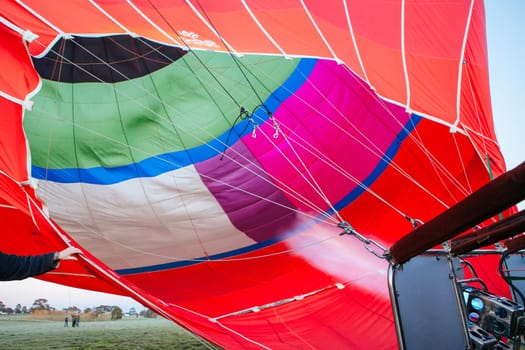 A blast of gas ignites, filling a hot air balloon with warm air on a cold winter's morning in Yarra Valley, Victoria, Australia