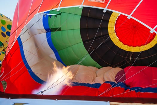 A blast of gas ignites, filling a hot air balloon with warm air on a cold winter's morning in Yarra Valley, Victoria, Australia