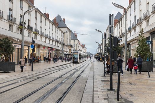 Tours, France - February 8, 2020: Electric tram rolling in a pedestrian street in the historic city center on a winter day