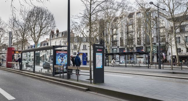 Tours, France - February 8, 2020: travelers in the Jean Jaures electric tram and bus station near the town hall on a winter day