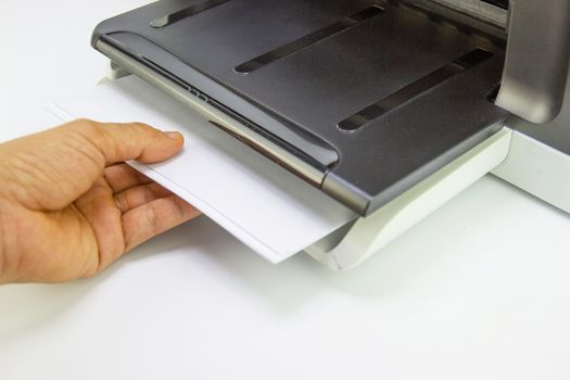 hand man lay down the paper from printer in the office, Business concept
