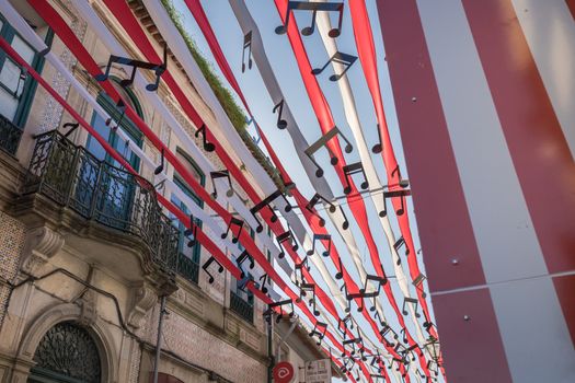 Ovar, Portugal - February 18, 2020: architectural detail of the typical houses of the city decorated for the carnival where people are walking on a winter day