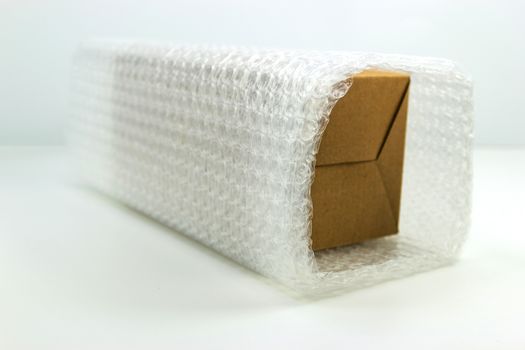 Bubbles covering the box by bubble wrap for protection product cracked white background