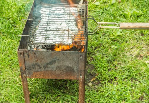 Cooking baked vegetables in foil on the grill. The concept of healthy eating, outdoor.