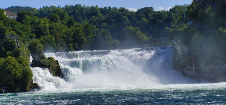 the famous rhine falls in the swiss near the city of Schaffhausen - sunny day and blue sky