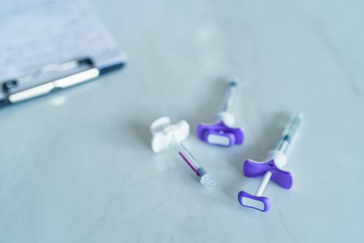 Group of plastic syringe for filler injection on white background. filler needle