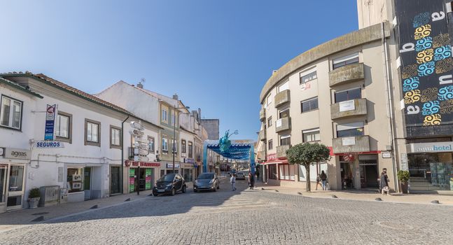 Ovar, Portugal - February 18, 2020: architectural detail of the typical houses of the city decorated for the carnival where people are walking on a winter day