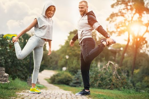 Urban sports - couple jogging for fitness in the city with beautiful nature.