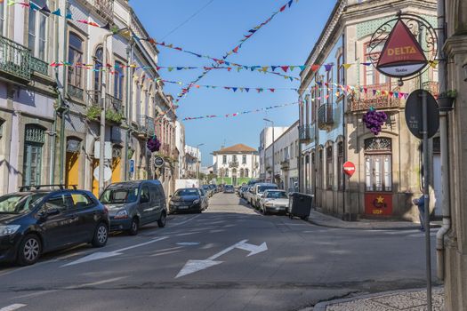 Ovar, Portugal - February 18, 2020: architectural detail of the typical houses of the city decorated for the carnival where people are walking on a winter day