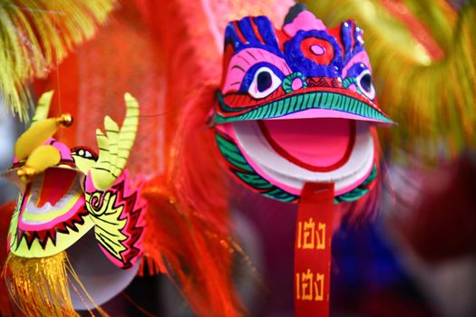 Bright colorful Dragon and Lion puppet paper toys being sold during a cultural chinese festival in Northern Thailand, Southeast Asia